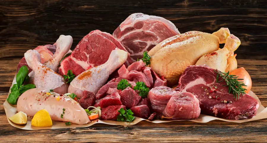 An assortment of raw meats, including: beef, chicken, and turkey