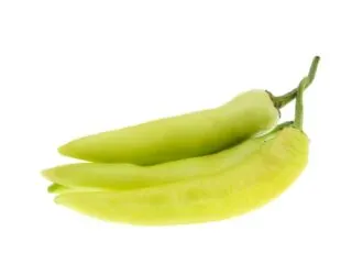 Photo of 3 yellowish green banana peppers against a white backdrop
