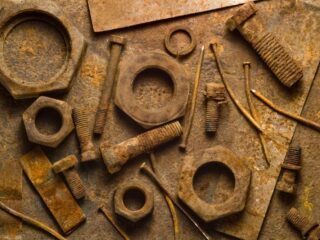 Photo of rusty tools on a rusty table backdrop