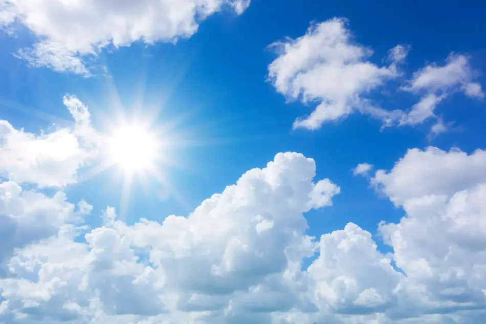 Photo of sunshine and clouds against a blue sky backdrop