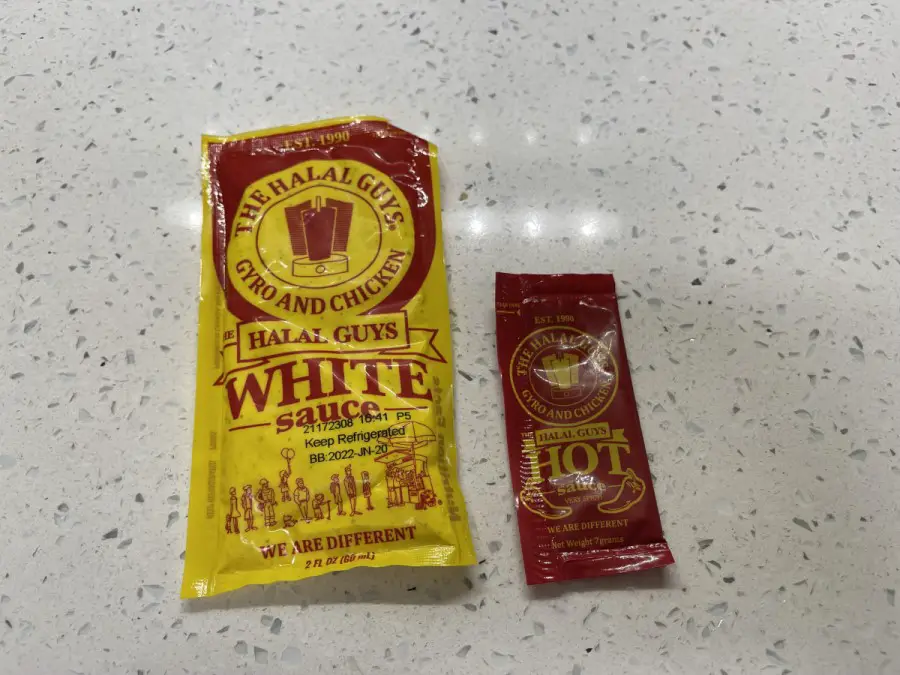 Halal Guys white sauce and hot sauce in the packets