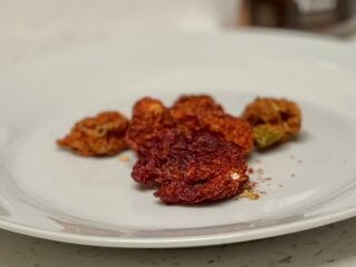 Dehydrated Carolina Reaper peppers on a white plate