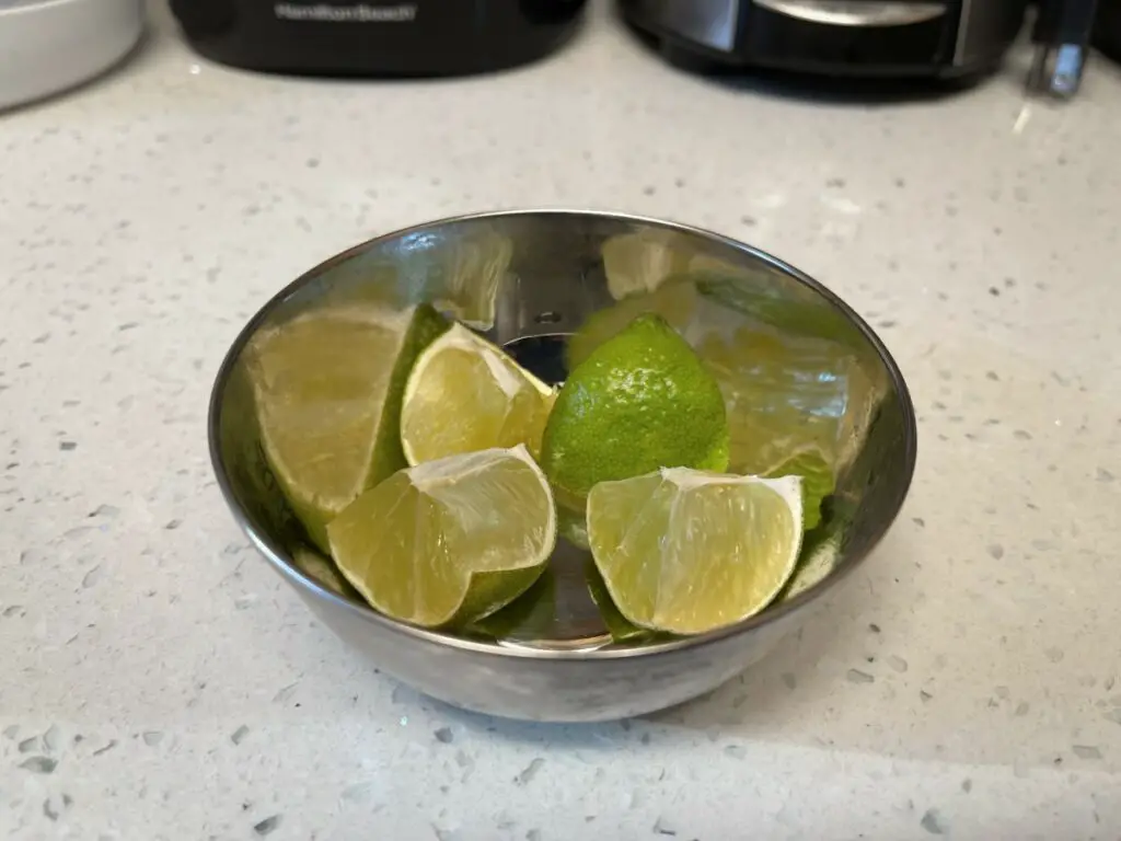 Small bowl of sliced open limes