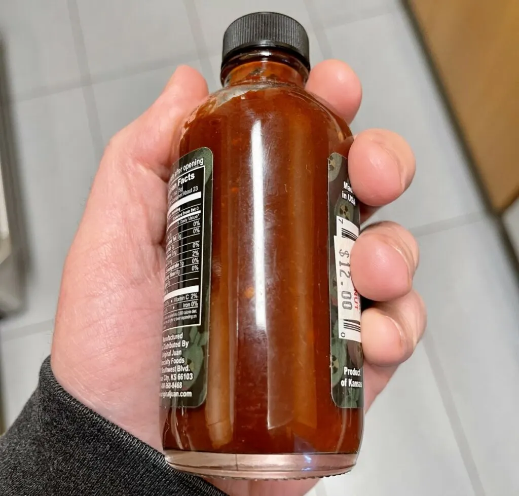 A shot bottle of hot sauce that has turned brown
