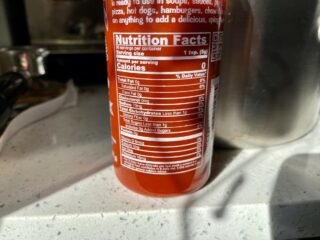 A photo of the nutritional label of Sriracha hot sauce showing zero calories